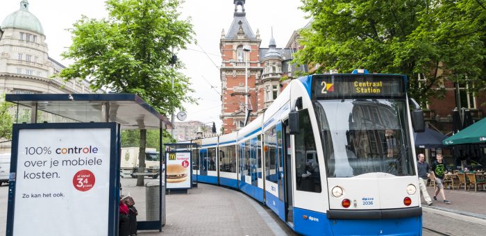 "Amsterdam, Holland - May 29, 2012: Tram running in the city centre amongst pedestrians. May 29, 2012 in Amsterdam. The tram network comprises 16 lines and covers 213 kilometres."